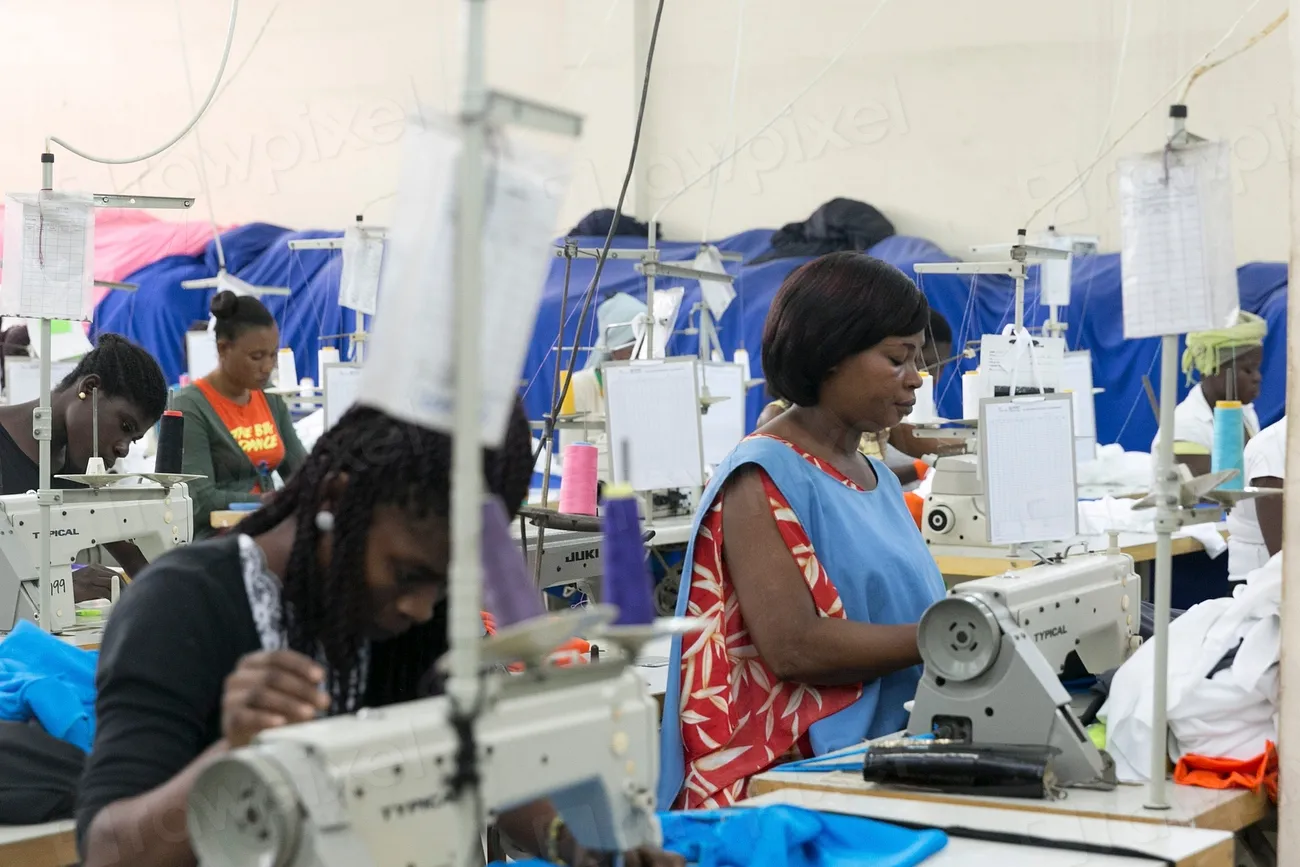 Workers sewing garments on a factory production line